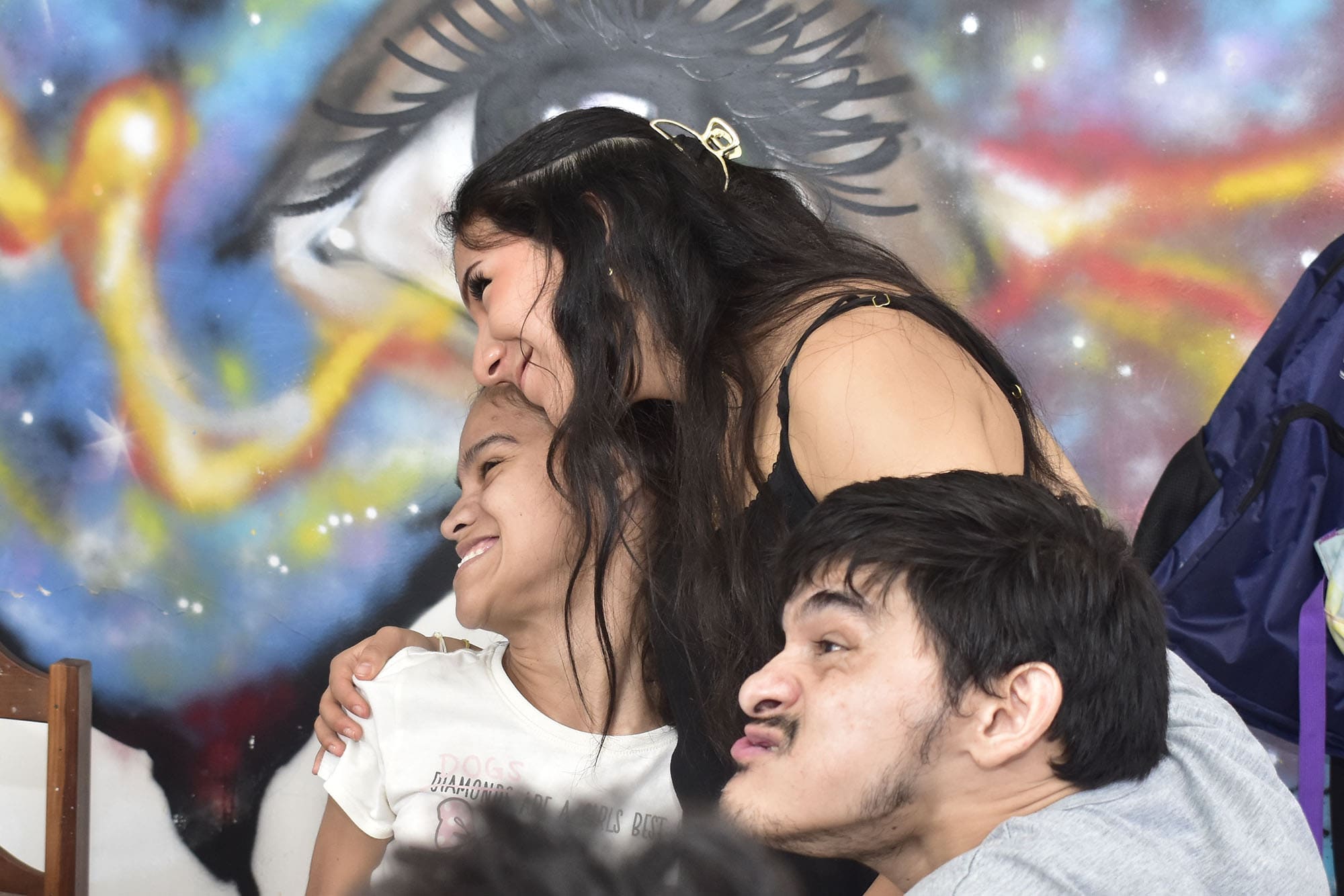 Caregiver sharing a moment of affection with participants in an inclusive community space